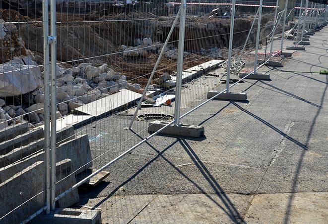 temporary fence panels protecting a job site from unwanted access